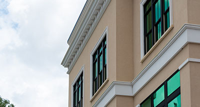 an exterior of a shop with a tinted and reflective window film